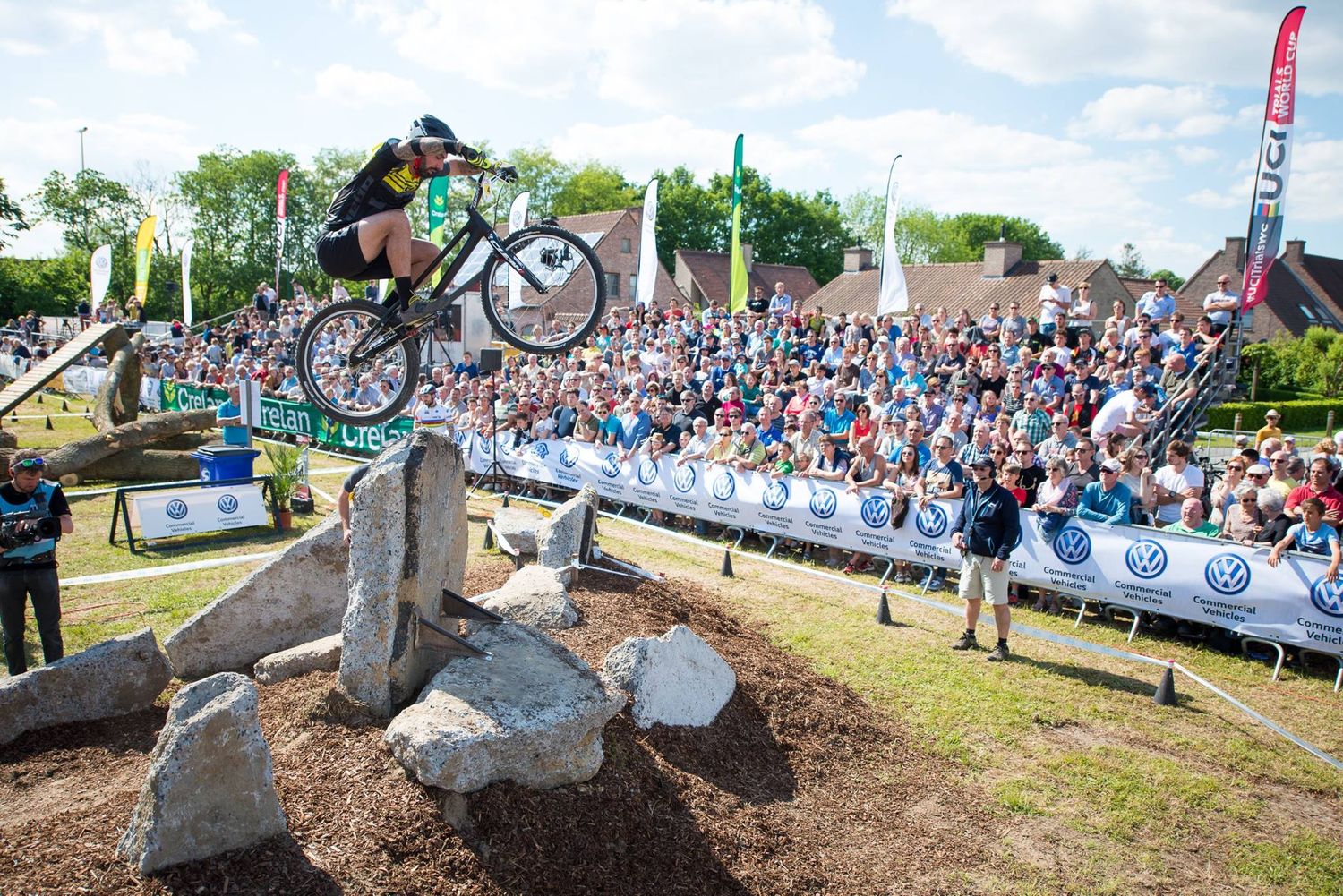 Example of a competition 26-inch rider on a professional course setup hopping up to a tall rock