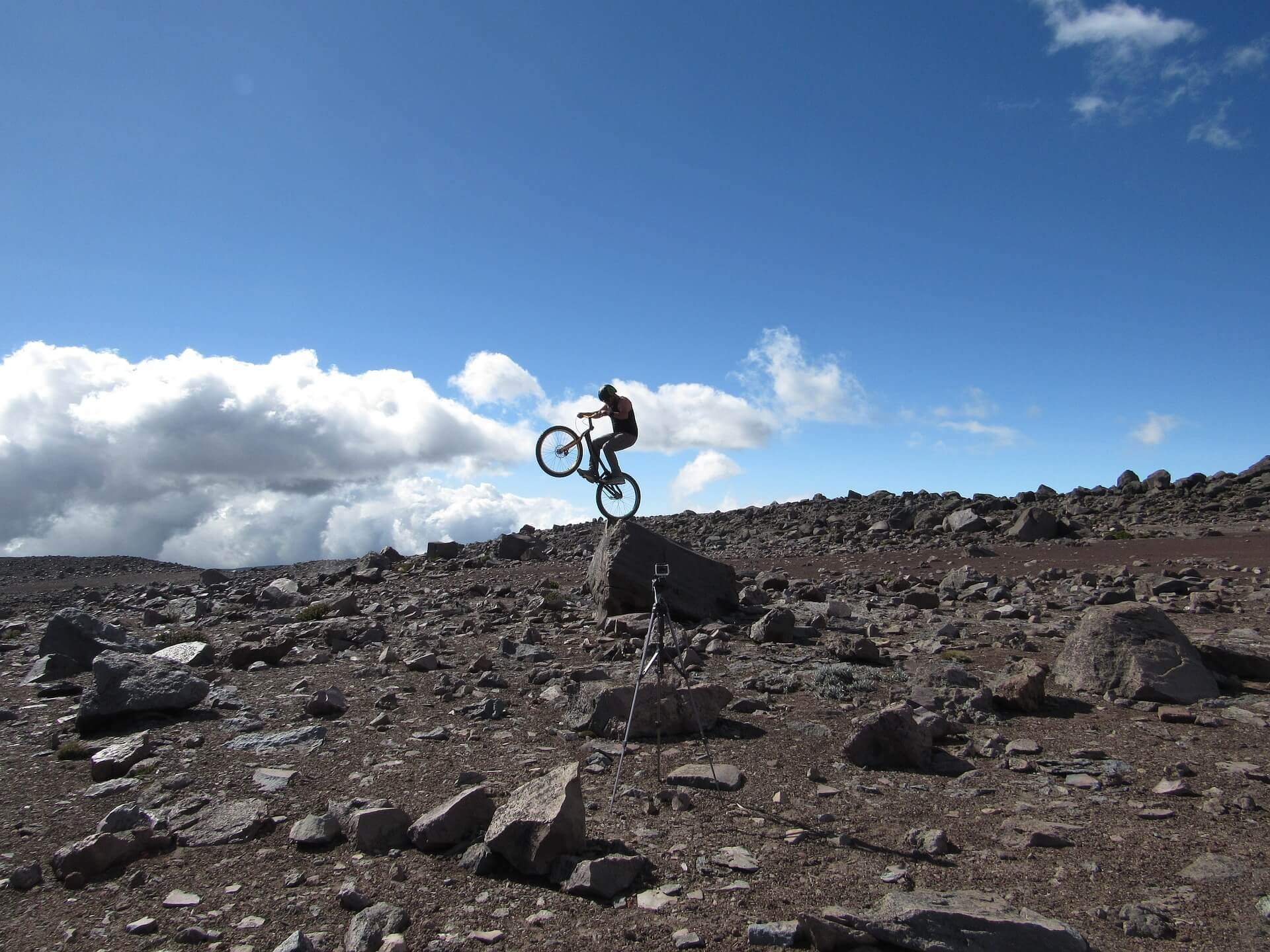 Rider balancing on a rock edge, rocky scenery