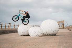 professional rider Danny Macaskill hopping across train tracks